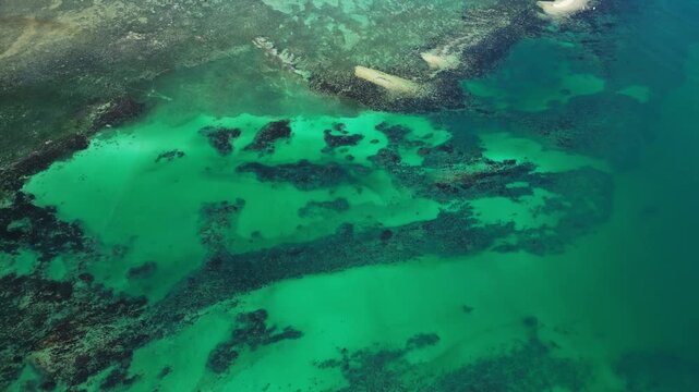 Wide aerial perspective showing a chain of small islands with blue and green crystal clear waters in Tondol.