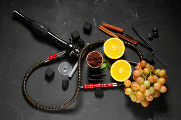 Parts of hookah with tobacco, berries, fruits and mint leaves on black background © Pixel-Shot
