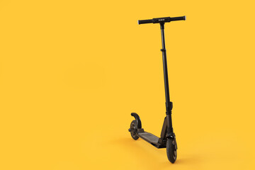 Modern electric scooter on yellow background © Pixel-Shot