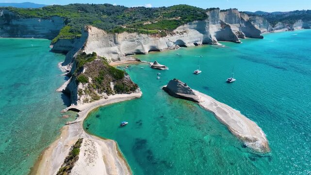 Spectacular Aerial Drone Footage of Cape Drastis in Corfu Greece Showcasing Unique White Clay Cliff Formations and Turquoise Lagoons of the Ionian Sea Popular Tourist Spot