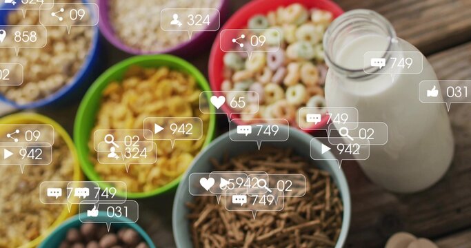 Displaying vibrant cereal bowls and milk bottle on rustic wooden breakfast table, with social icons