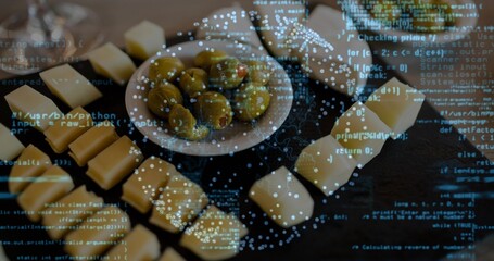 Displaying bowl of marinated olives and cheese on dark wooden board, showing code and blue bokeh