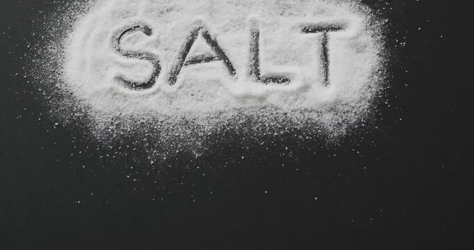 Animation of salt text written in salt on black background