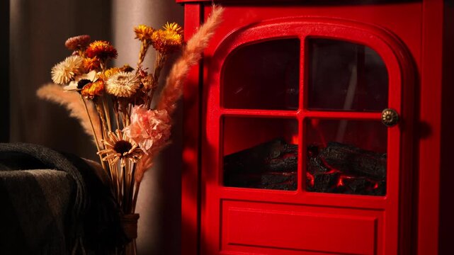 A warm and inviting winter scene with a retro red fireplace.