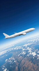 Naklejka premium Commercial Airplane Soaring High Above Earth with Blue Sky and Clouds.