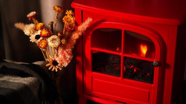 A warm and inviting winter scene with a retro red fireplace.
