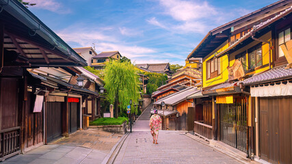 Girl wearing a traditional Japanese kimono with red umbrella  at old town  Kyoto, Japan