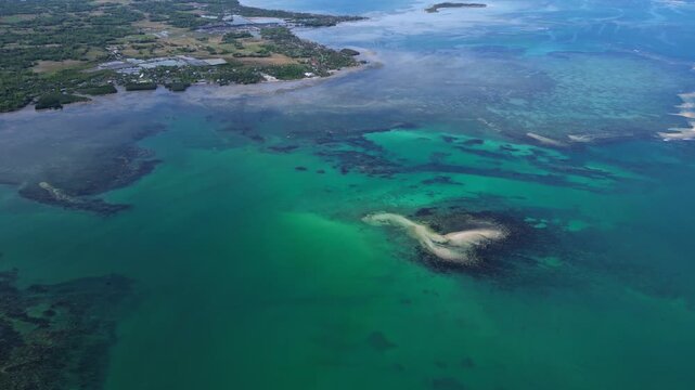 Wide horizon aerial showing Tondol islands surrounded by calm blue green water and tropical coastal scenery.