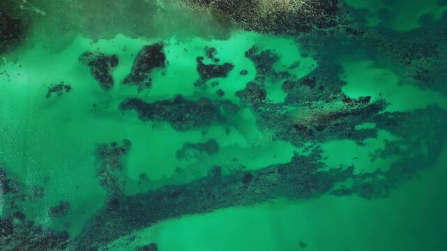 Wide aerial focusing on calm lagoon waters and surrounding islands at Tondol, Anda Pangasinan.