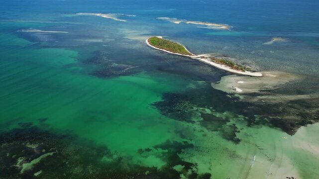 High altitude drone shot showing multiple Tondol islands with vibrant blue green waters and sandy edges.