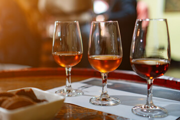 Wine and port tasting in glasses on the table.