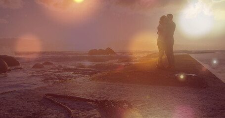 Obraz premium Image of light spots over african american couple at beach