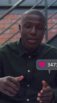 Vertical video: Man explaining on steps, speech initiating social bubbles eliciting tapping