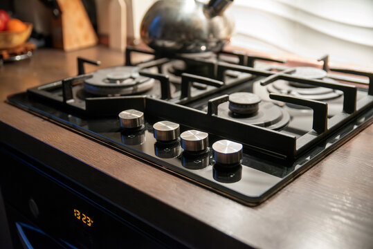 Modern black gas cooktop with knobs