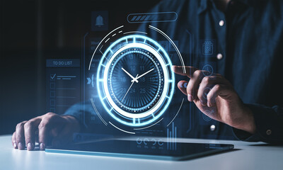 Obraz na płótnie Canvas Futuristic digital time management interface with glowing clock and calendar on virtual screen concept background controlled by a person using a tablet.