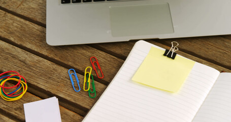 Image of keep your desk clean text on yellow memo note on desk with laptop, coffee and notebook