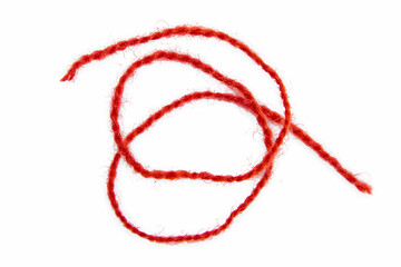 Red thread isolate on white background. Selective focus. Old.