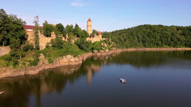 Leisure motorboat near the medieval Zvikov Castle on Orlik Reservoir