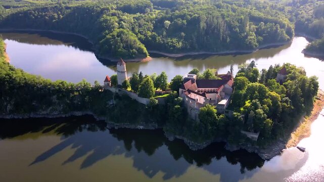 Aerial sunset view of Zvikov Castle above Orlik Reservoir in Czech landscape