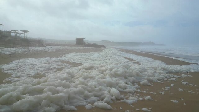 Flying at a cloudy day at Guincho beach, above the white foam, a common natural phenomenon caused by the agitation of the waves mixing air with dissolved organic matter.Guincho beach,Cascais,Portugal