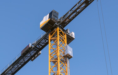 close-up of a tower crane against a clear blue sky