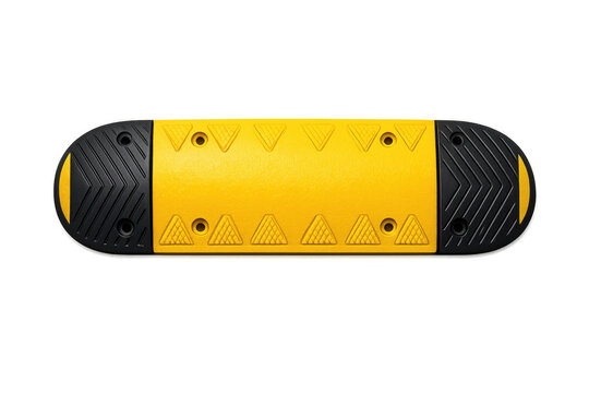 Yellow and black speed bump with textured surface and reflective elements on a black background