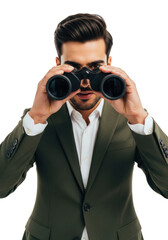 Handsome young south asian businessman in a slim olive green suit jacket, intensely looking through black binoculars against a bright white studio backdrop. Concept of detailed investigation
