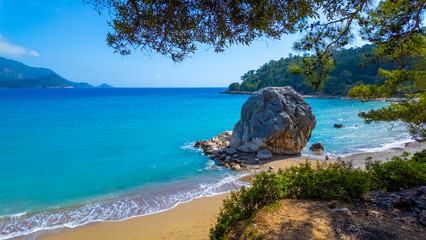 A scenic view of a beach on Mediterranean coast of Turkey. Mediterranean beach during summer vacation. Nature view for summer vacation. 