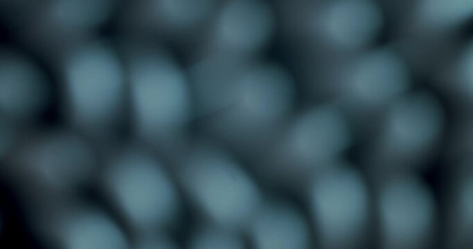 Abstract background featuring a soft, out-of-focus honeycomb or net pattern in a dark teal color, with gentle, slow-moving light creating a calming and atmospheric visual effect