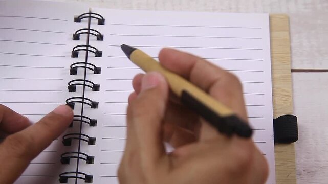 Video of hand writing on a notebook