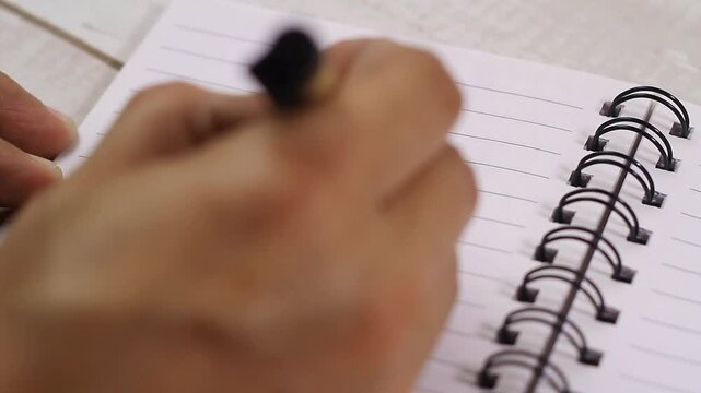 Video of hand writing on a notebook