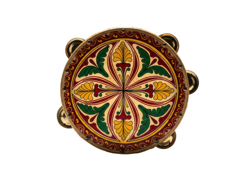 Vintage tambourine with detailed hand-painted latin american folk art in glossy red, yellow, and green enamel, reflecting studio light against a transparent background. concept of vibrant cultural