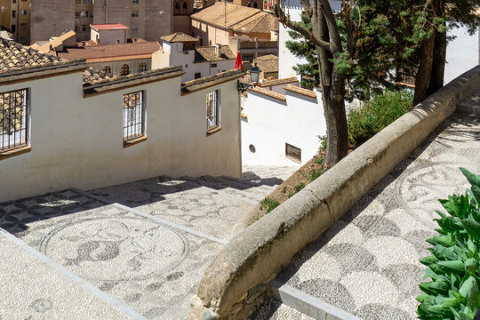 Traditional Empedrado Granadino Pebble Mosaic Stairs in Albaicin Granada Spain with Pomegranate Symbol and Geometric Patterns in Historic UNESCO World Heritage Site