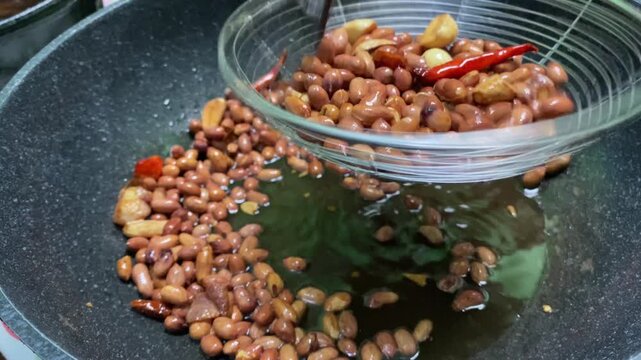 Fried peanuts. This is the stage for making pecel or gado-gado sauce, which is based on peanuts, this is the frying process.
