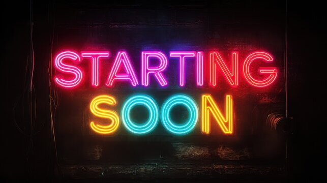 Bright neon sign displays the phrase starting soon in multiple colors at a casual event location