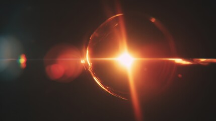 Bright light shines through a spherical lens creating reflections and patterns in a dark space