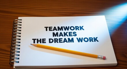 Fototapeta premium Teamwork Makes The Dream Work Motivational Quote on Notebook with Pencil, Representing Collaboration and Success