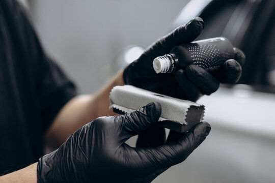 Man at car service doing car ceramic , coating car procedure