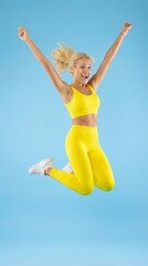 Joyful Leap: A woman leaps for joy, radiant in vibrant activewear against a clear, blue expanse. Capturing the essence of unbridled happiness and the spirit of wellness and movement.
