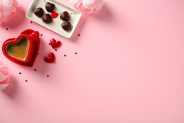 Romantic flat lay with coffee, chocolates, and flowers on a pink background. Happy Valentine's Day...