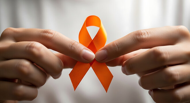 A person holds an orange awareness ribbon, symbolizing support for various health conditions like multiple sclerosis