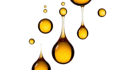 Golden honey or caramel syrup droplets hanging and splashing in midair on white background for food advertising