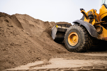 Wheel Loader Collecting Sand For