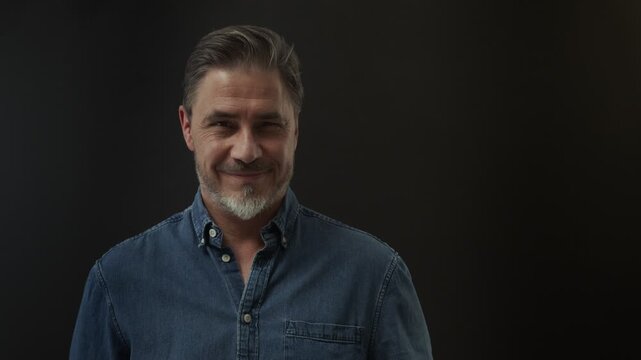 Portrait of mature age, middle age, mid adult man in 50s, happy confident smile. Copyspace.