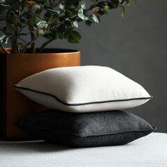 Two neutral-toned throw pillows rest atop one another.