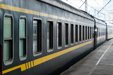 The green train, China Railway, is parked at the platform