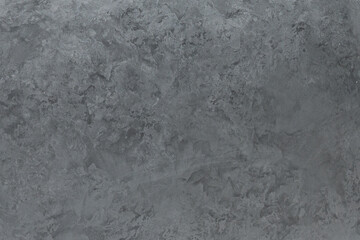 Obraz premium Texture of a gray background with a rough surface showing uneven patterns and depths in various shades