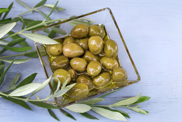 glass bowl filled with green olives
