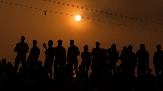 Group of people in silhouette during sunset at Morocco Taghazout skatepark, cinematic urban travel mood