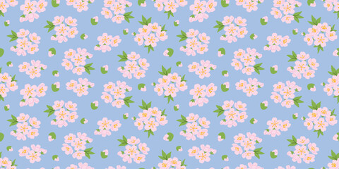 Seamless vector pattern with delicate pink cherry blossom flowers and green leaves on soft blue background. Elegant floral design for textile printing, fabric, wrapping paper and spring decor